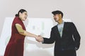 Business partners shaking hands after concluding a business presentation finished. Business man and woman standing in front of Royalty Free Stock Photo