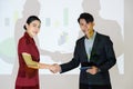 business partners shaking hands after concluding a business presentation finished. Business man and woman standing in front of Royalty Free Stock Photo