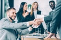 business partners shaking hands with multicultural blurred colleagues Royalty Free Stock Photo