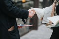 Business partners shaking hands at an outdoor meeting, collaboration in progress Royalty Free Stock Photo