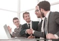 Business partners shaking hands sitting at the office table Royalty Free Stock Photo