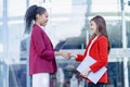 Business partners shaking hands standing in front of his office Two young young businesswomen shaking hands Royalty Free Stock Photo