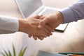 Business partners shaking hands at table in office Royalty Free Stock Photo