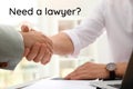 Business partners shaking hands at table in office. Need a lawyer