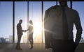 Business partners silhouettes shaking hands