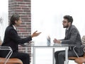 Business partners talking while sitting at your Desk Royalty Free Stock Photo