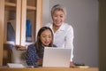 Business partners women collaborating and coworking happy and successful at office laptop computer desk in job female colleagues Royalty Free Stock Photo