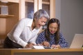 Business partners women collaborating and coworking happy and successful at office laptop computer desk in job female colleagues Royalty Free Stock Photo