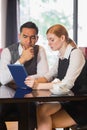 Business partners working on tablet pc together in a cafe Royalty Free Stock Photo