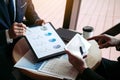 Business partnership coworkers using a tablet to chart company financial statements report and profits work progress and planning Royalty Free Stock Photo