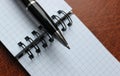 Business Pen On A Binder Of Checkered Note On A Leather Folder Royalty Free Stock Photo