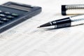 Business pen, calculator on financial chart Royalty Free Stock Photo