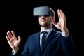 Businessman in virtual reality headset over black Royalty Free Stock Photo