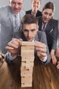 Business people building wood tower