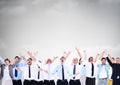 Business people celebrating success under grey sky