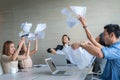 Business people celebrating by throwing documents after working Royalty Free Stock Photo