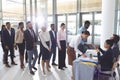 Business people checking in at conference registration table