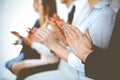 Business people clapping and applause at meeting or conference, close-up of hands. Group of unknown businessmen and