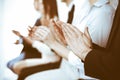 Business people clapping and applause at meeting or conference, close-up of hands. Group of unknown businessmen and