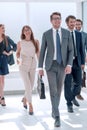 Business people confidently walking in a modern office building Royalty Free Stock Photo