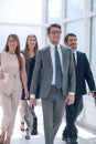 Business people confidently walking in a modern office building Royalty Free Stock Photo