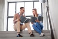 Man and woman with folders at office stairs Royalty Free Stock Photo