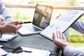 Business people discuss together about there work by graph document and setting in outdoor for planning financial strategy. Royalty Free Stock Photo