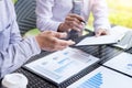 Business people discuss together about there work by graph document and setting in outdoor for planning financial strategy. Royalty Free Stock Photo