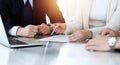 Business people discussing contract while working together in sunny modern office. Unknown businessman and woman with Royalty Free Stock Photo