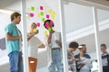 Business people discussing over sticky notes in the office Royalty Free Stock Photo