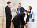 Business people drinking water at water cooler Royalty Free Stock Photo