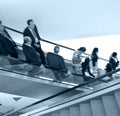 Business people on the escalator Royalty Free Stock Photo