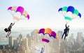 Business people falling down on parachutes Royalty Free Stock Photo