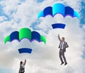 Business people falling down on parachutes Royalty Free Stock Photo