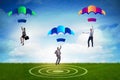 The business people falling down on parachutes Royalty Free Stock Photo