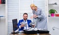 Business, people and finances concept. Falling pennies. Happy and excited man sitting at table covered with money and Royalty Free Stock Photo