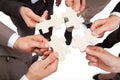 Business people fixing jigsaw pieces