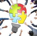 Business People Forming a Light Bulb Puzzle Royalty Free Stock Photo