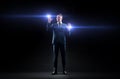 Businessman with laser light over black