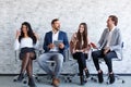 Business people at a conference in the office with phones in hands Royalty Free Stock Photo