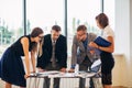 Business people gathered together at a table discussing an idea Royalty Free Stock Photo