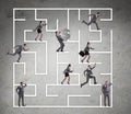 Business people getting lost in maze uncertainty concept Royalty Free Stock Photo