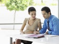 Business People Going Over Document Information At Desk Royalty Free Stock Photo