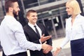 Business people greeting outside modern building