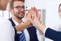 Business people group happy showing teamwork and joining hands or giving five after signing agreement or contract in