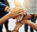 Business people hands stacked together showing unity, teamwork and collaboration in a multicultural or diverse business