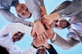 Business people, hands together and teamwork in unity below blue sky for agreement or collaboration outdoors. Group of