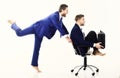 Business people have fun and ride on office chair. Royalty Free Stock Photo