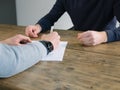 Business, people have meeting round a wooden table at an office