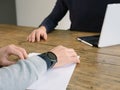 Business, people have meeting round a wooden table at an office with laptop